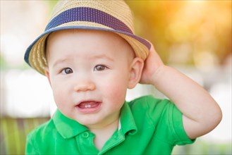 Portrait of A happy mixed-race chinese and caucasian baby boy wearing his hat