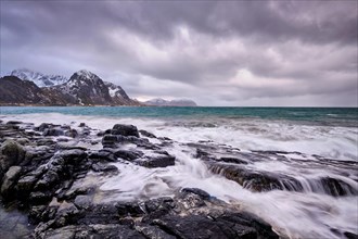 Rocky coast of fjord of Norwegian sea in winter. Vareid