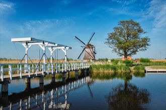 Netherlands rural landscape with windmills and bridge at famous tourist site Kinderdijk in Holland