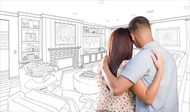 Curious young military couple looking over custom living room design drawing