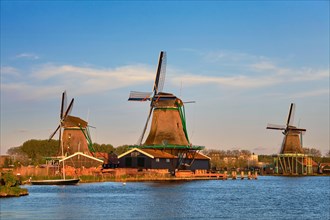 Windmills at famous tourist site Zaanse Schans in Holland in twilight on sunset with moon. Zaandam