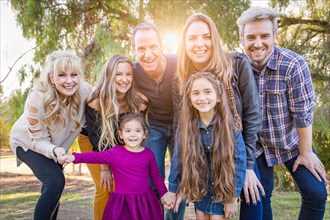 Multigenerational mixed-race family portrait outdoors