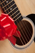 Guitar strings with red ribbon