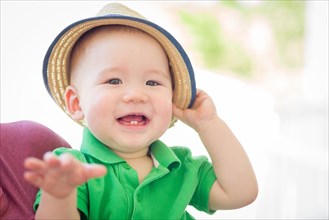 Portrait of A happy mixed-race chinese and caucasian baby boy wearing his hat