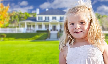 Cute smiling girl playing in front yard of house