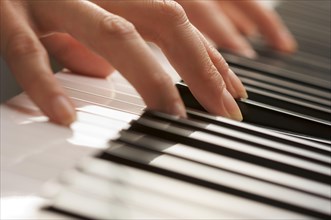 Woman's fingers on digital piano keys