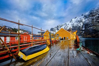 Nusfjord authentic fishing village in winter with red and yellow rorbu houses. Lofoten islands