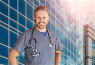 Caucasian male nurse in front of hospital building