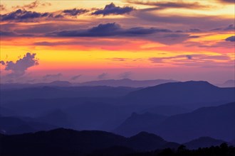 Silhouettes of hills in valley on sunset. Pothamedu viewpoint