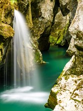 Waterfall plunges into the emerald green Soca River