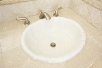 Shell shaped sink and faucet and tile counter