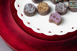 Artisan fine chocolate candy on serving dish with heart design