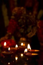 Diwali lights oil candles with Shiva Nataraja in the background for Maha Shivaratri