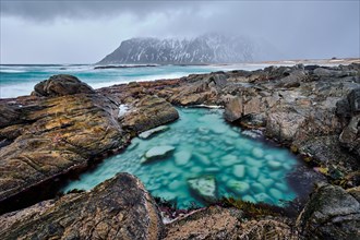 Rocky coast of fjord of Norwegian sea in winter. Lofoten islands