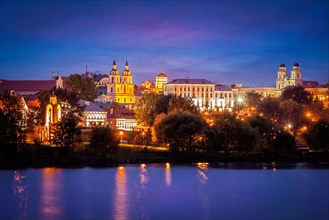 Evening view of Minsk cityscape with Holy Spirit Cathedral over Svisloch River