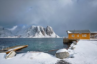 Yellow traditional rorbu house in Sakrisoy fishing village in winter on Lofoten Islands