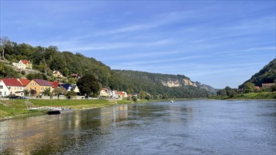 View from the ferry on the Elbe to the town of Wehlen and Bastei in the background