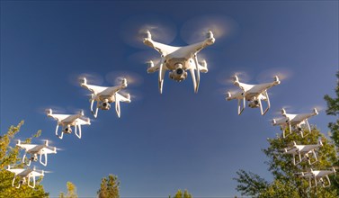Formation of drones swarm in the blue sky