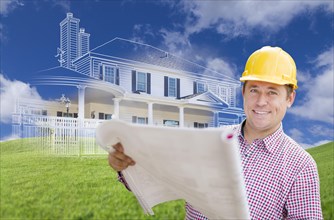 Smiling contractor holding blueprints over custom home drawing and photo combination