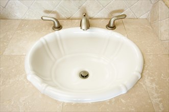 Shell shaped sink and faucet and tile counter