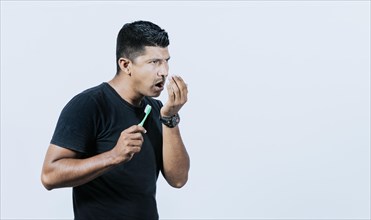 Person with brush with bad breath problem