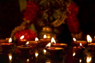 Diwali lights oil candles with Shiva Nataraja in the background for Maha Shivaratri