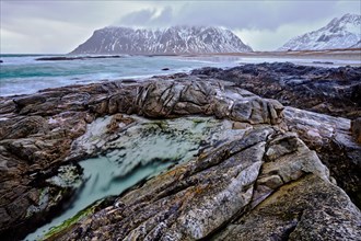 Rocky coast of fjord of Norwegian sea in winter. Lofoten islands