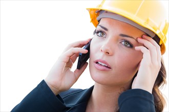 Concerned female contractor in hard hat using cell phone isolated on white