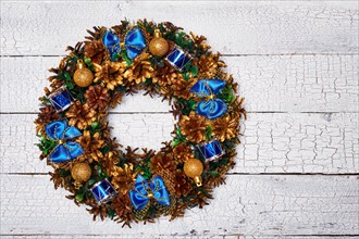 Christmas wreath on white painted wooden background