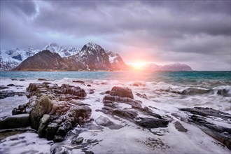 Rocky coast of fjord of Norwegian sea in winter on sunset. Vareid