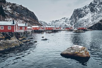 Nusfjord authentic traditional fishing village with traditional red rorbu houses in winter in Norwegian fjord. Lofoten islands