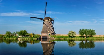 Panorama of Netherlands rural landscape with windmills at famous tourist site Kinderdijk in Holland
