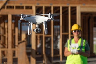 Female pilot flies drone quadcopter inspecting construction site
