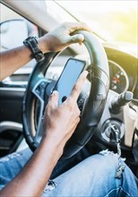 Close up of driver hands using his phone