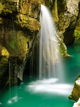 Waterfall plunges into the emerald green Soca River