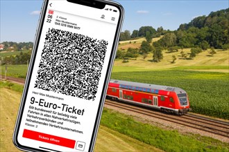 9-euro ticket on mobile phone with regional train Photo montage in Uhingen