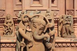 Statue of an elephant god and various deities