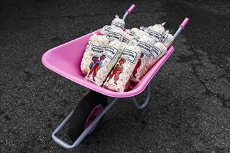Pink wheelbarrow with popcorn bag