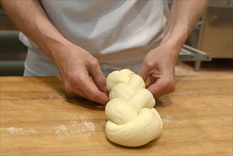 Bakers plaiting butter plait
