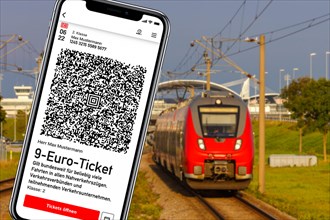 9-euro ticket on mobile phone with regional train Photo montage in Munich