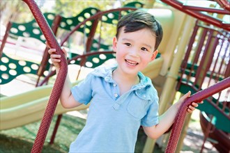 Chinese and caucasian boy having fun at the playground