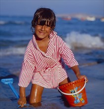 Child on the beach bucket and shovel