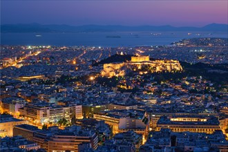 Parthenon Temple on hill is the antique tourist landmark at the Acropolis of Athens and ancient European civilization architecture on Aegean sea coast. Dusk view from Mount Lycabettus