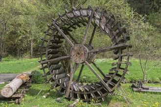 Disused mill wheel set up as decoration at a mill