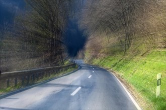 Tunnel vision of motorist speeding at excessive speed on dangerous winding country road