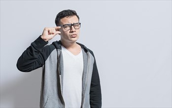 People gesturing with his hand showing something small size with his fingers. man measuring something with fingers