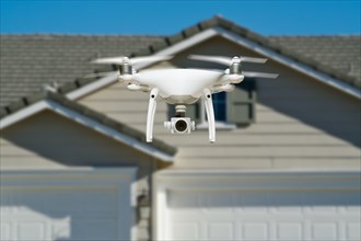Unmanned aircraft system quadcopter drone in the air near house