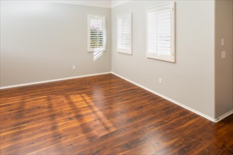 Newly installed brown laminate flooring and baseboards in home