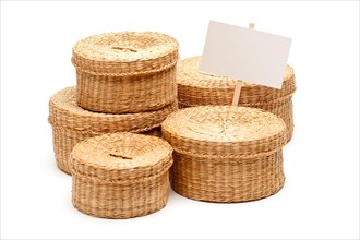 Various sized wicker baskets with blank sign isolated on white