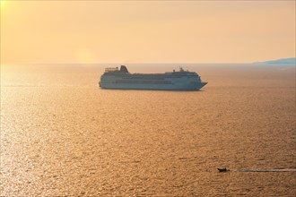 Cruise ship and yacht boat silhouettes in Aegean sea on sunset